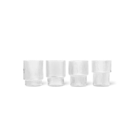 Four white cylindrical glasses on a white background